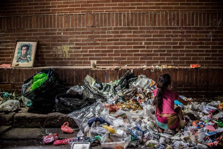 © Federico Parra. A girl scavanges for food in the streets of Caracas on February 22, 2017. Public hospital doctors declared that hunger is killing Venezuelan children at an alarming rate.