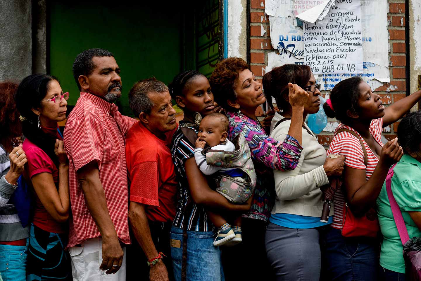 © Federico Parra. People queue up to buy food and basic household items in a supermarket at the Petare neighborhood in Caracas on July 16, 2016. The Venezuelan military began overseeing food distribution at ports, airports and businesses as part of a plan by President Nicolas Maduro to alleviate acute shortages plaguing the country.