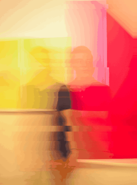 nicolas-ladino-silva-y88uVd4tcNo-unsplash.jpg A joung man standing on a yellow and red background edited with a motion effect