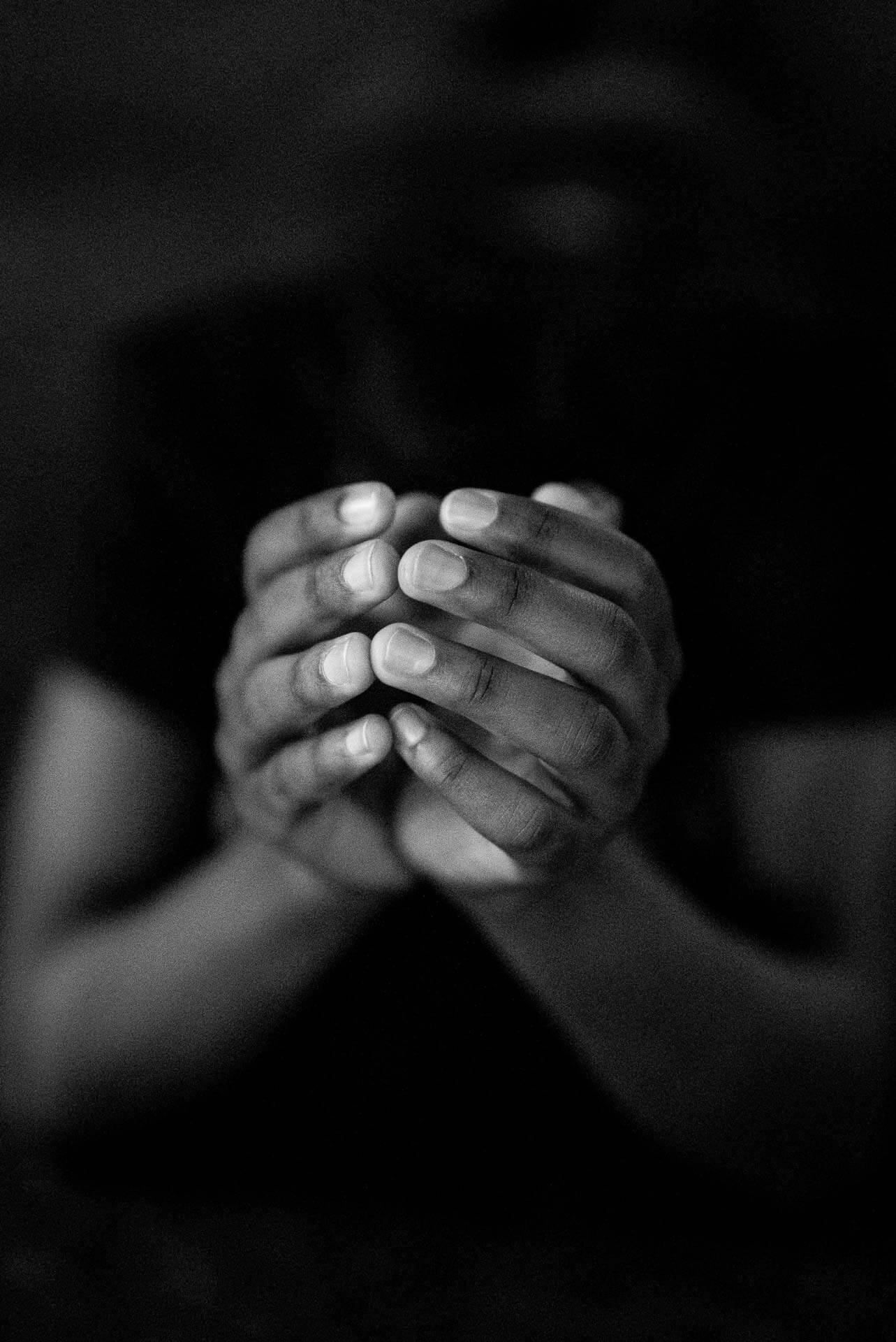Black hands in a prayer