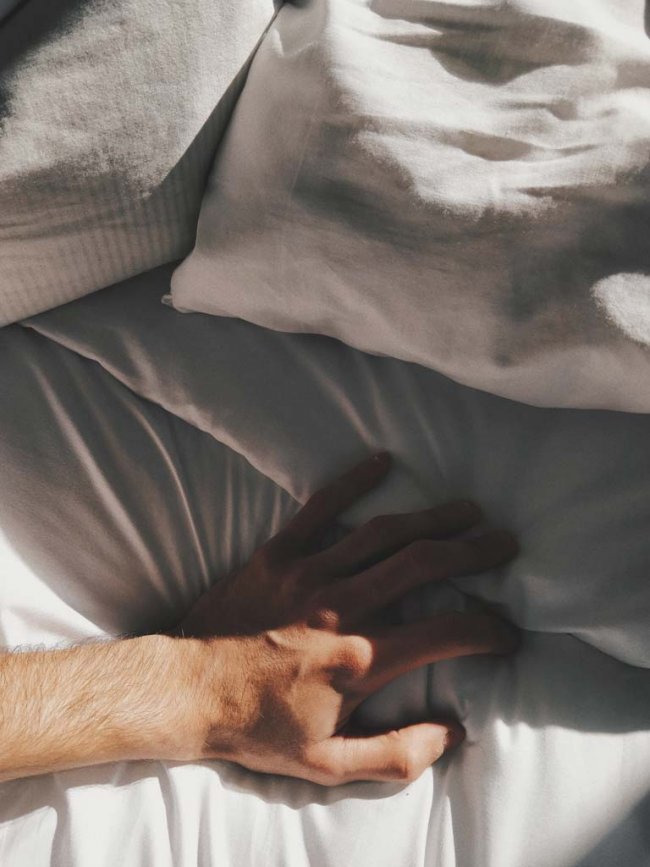 hugo-IvvRg49Vz3c-unsplash Man hand searching under a white pillow